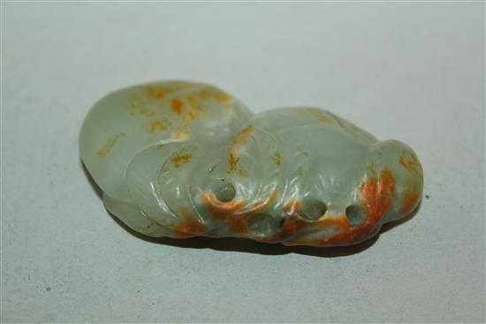 A Chinese celadon and russet jade carving of two peaches, 19th / 20th century, 6cm